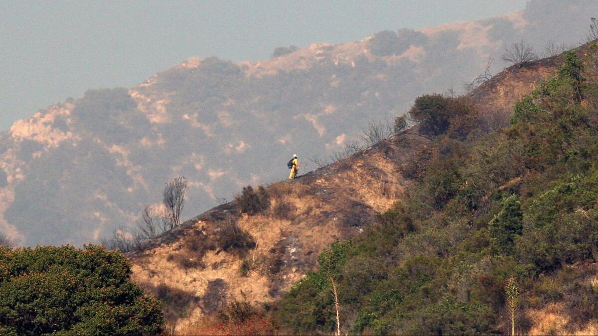 A fireman looks over a hot spot on Wednesday, July 26, 2017.