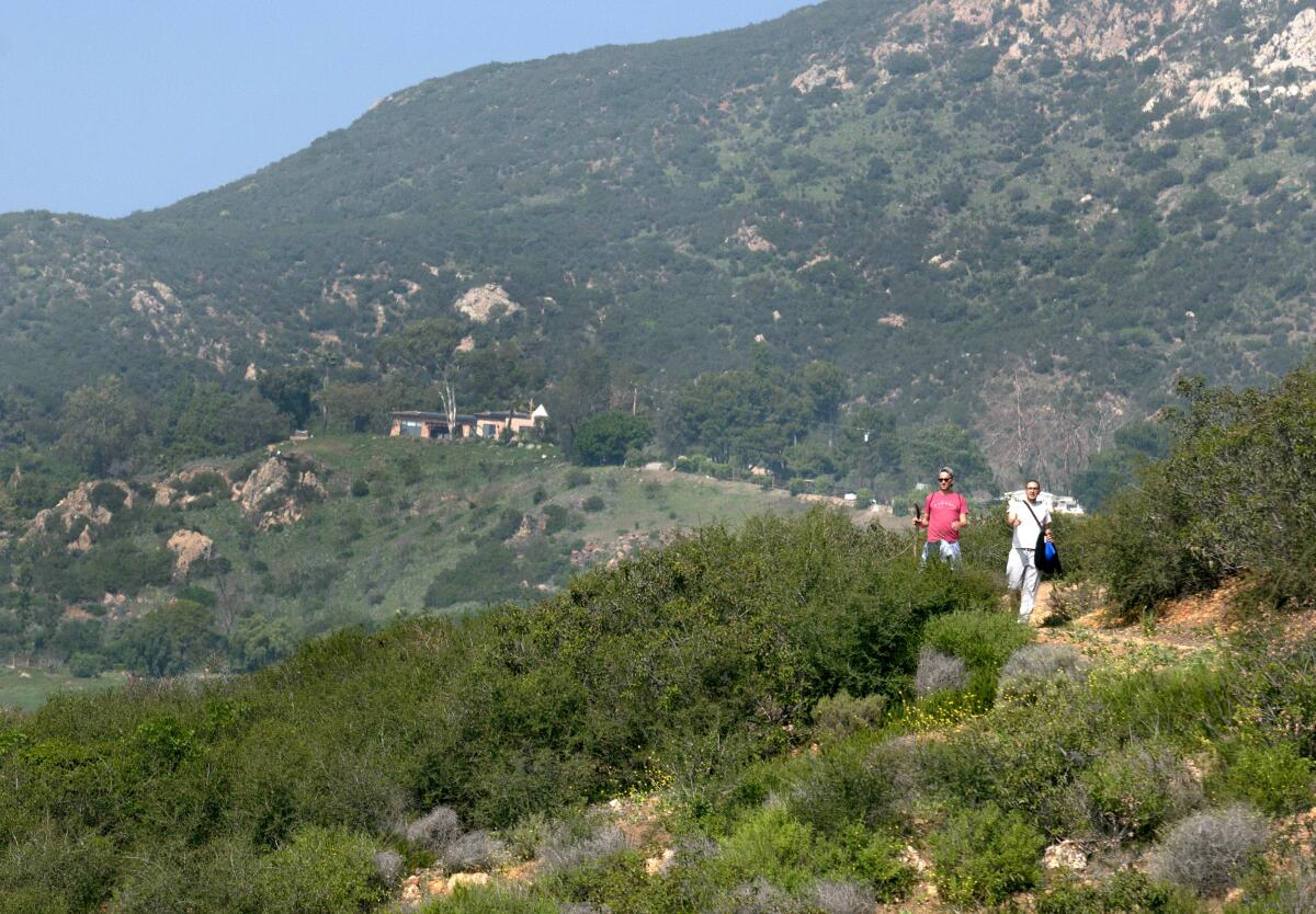 File photo of hikers walking along the Rising Sun Trailhead in Solstice Canyon in Malibu. 