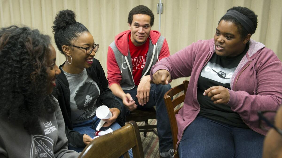 Google software engineer Sabrina Williams, right, talks with students during a class at Howard University in Washington, D.C. Google has embedded engineers at a handful of historically black colleges, where they teach and advise on curriculum.