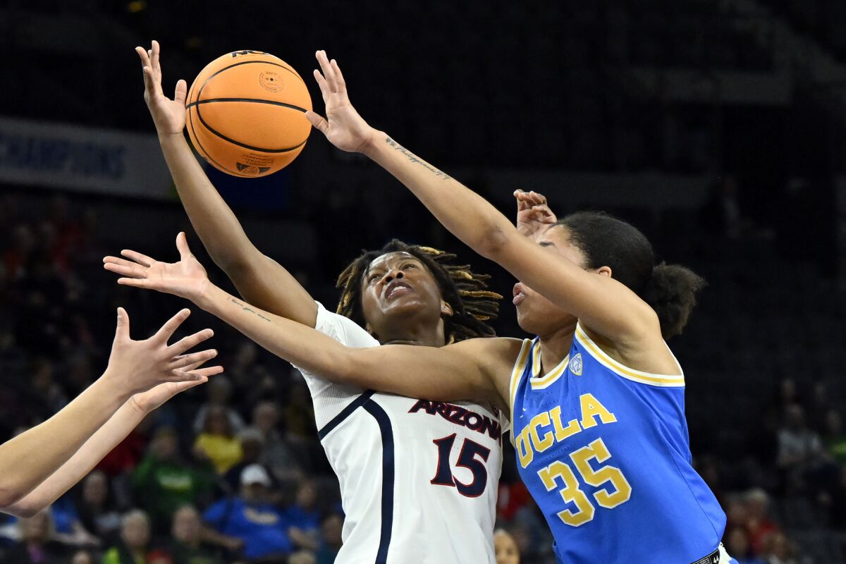 Arizona guard Kailyn Gilbert and UCLA guard Camryn Brown battle for the ball.