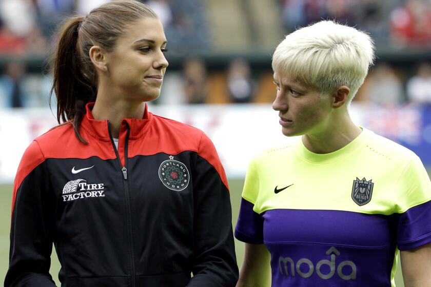 Thorns forward Alex Morgan, left, and Reign forward Megan Rapinoe stare down each other before a NWSL game on July 22.