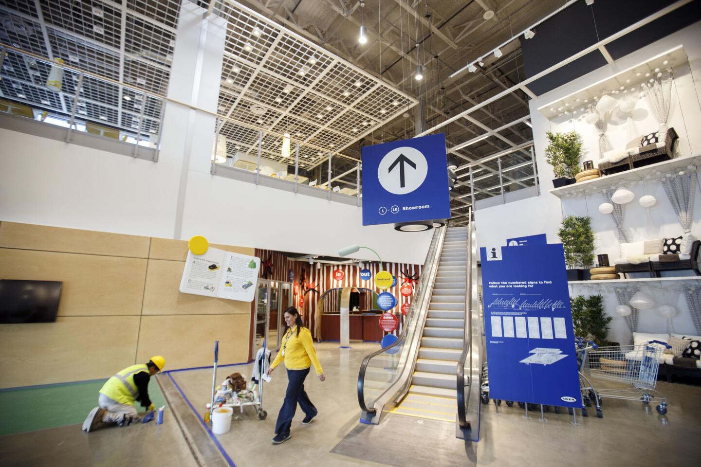 A worker puts the finishing touches on the entrance to the new Ikea in Burbank.