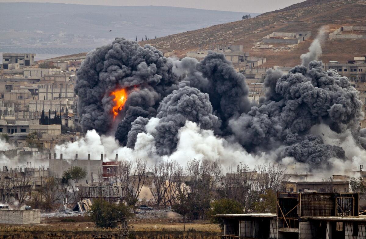 Smoke rises from the Syrian city of Kobani on Nov. 17 following an airstrike by the U.S.-led coalition, as seen from a hilltop outside the nearly Turkish city of Suruc.