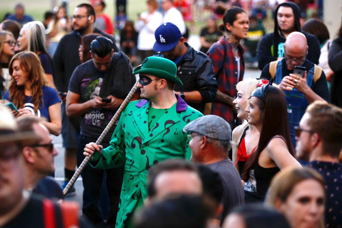 Dressed as the Riddler, Chad Evett, 30, of Los Angeles, takes part in the Bat-signal tribute to Adam West on June 15.
