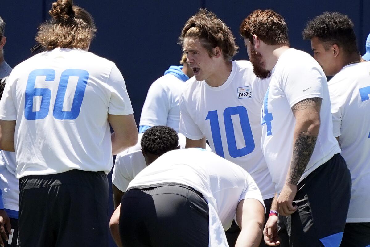 Chargers quarterback Justin Herbert (10) huddles with teammates during a practice in May.