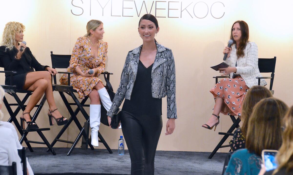 Nordstrom Fashion Island beauty stylist Lyudmila DeChante-Tate, celebrity stylist Lindsay Albanese and Fashion Island’s lead personal shopper, Sara Aplanalp, from left, watch a model wearing a snake jacket by Iro and leather pants by Vinces and Cami by Frame during StyleWeekOC 2019.