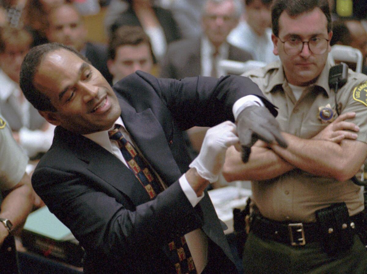 O.J. Simpson tries on one of the leather gloves prosecutors said he wore the night his ex-wife Nicole Brown Simpson and Ron Goldman were murdered during his 1995 trial in Los Angeles.