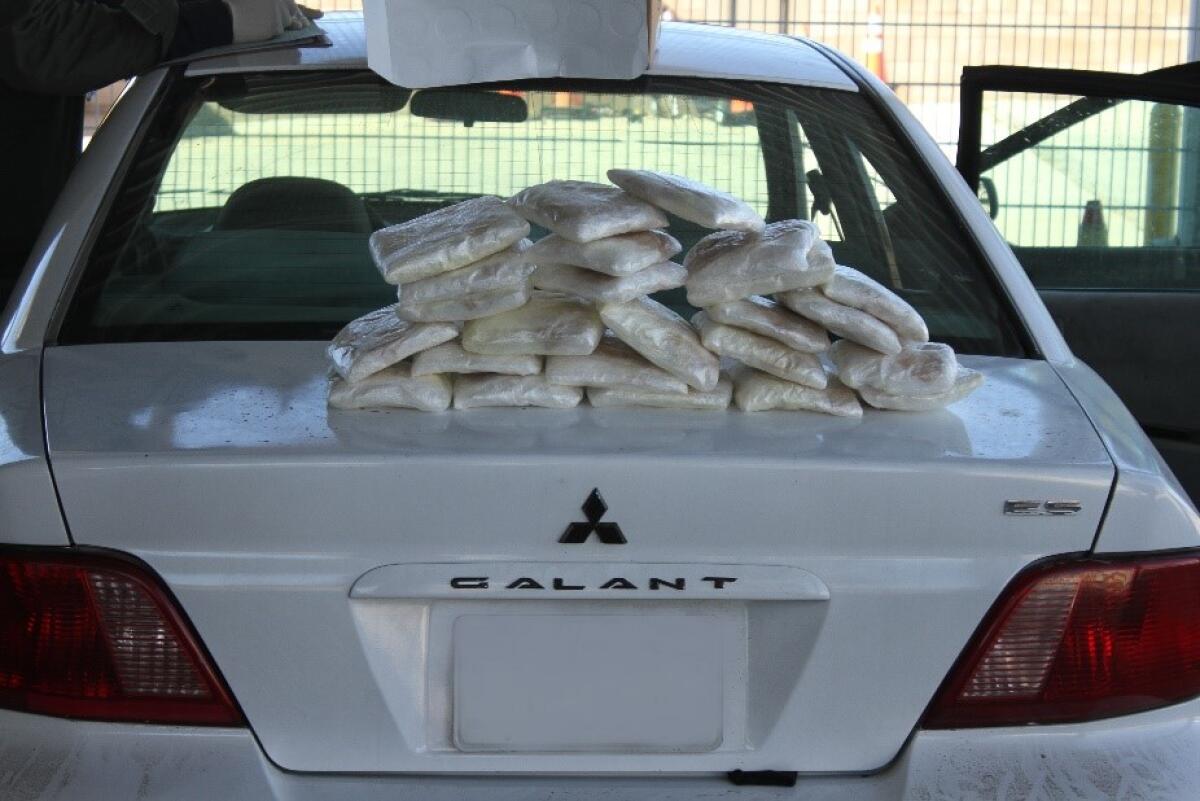 Bundles of methamphetamine sit on the truck on a car.