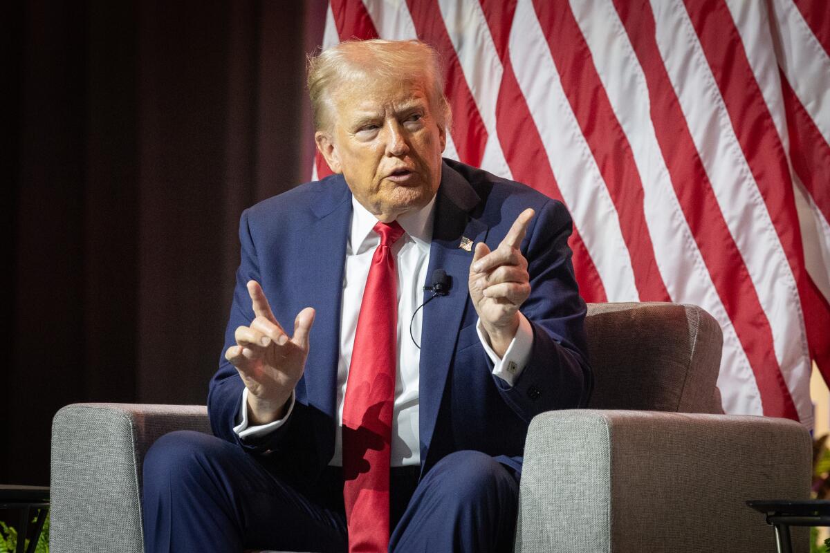 Former President Trump speaks while gesturing at the National Association of Black Journalists