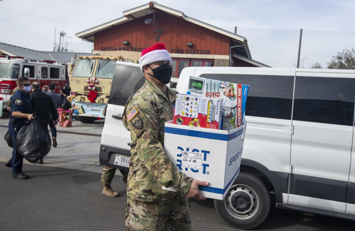 Sgt. 1st. Class Kenneth Kinney carries donated toys for Operation Christmas.