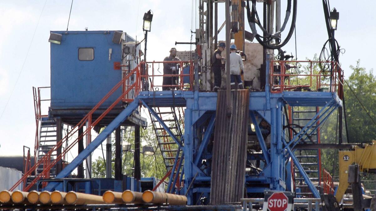 A crew works on a natural gas drilling rig at a site in Pennsylvania for shale-based natural gas.