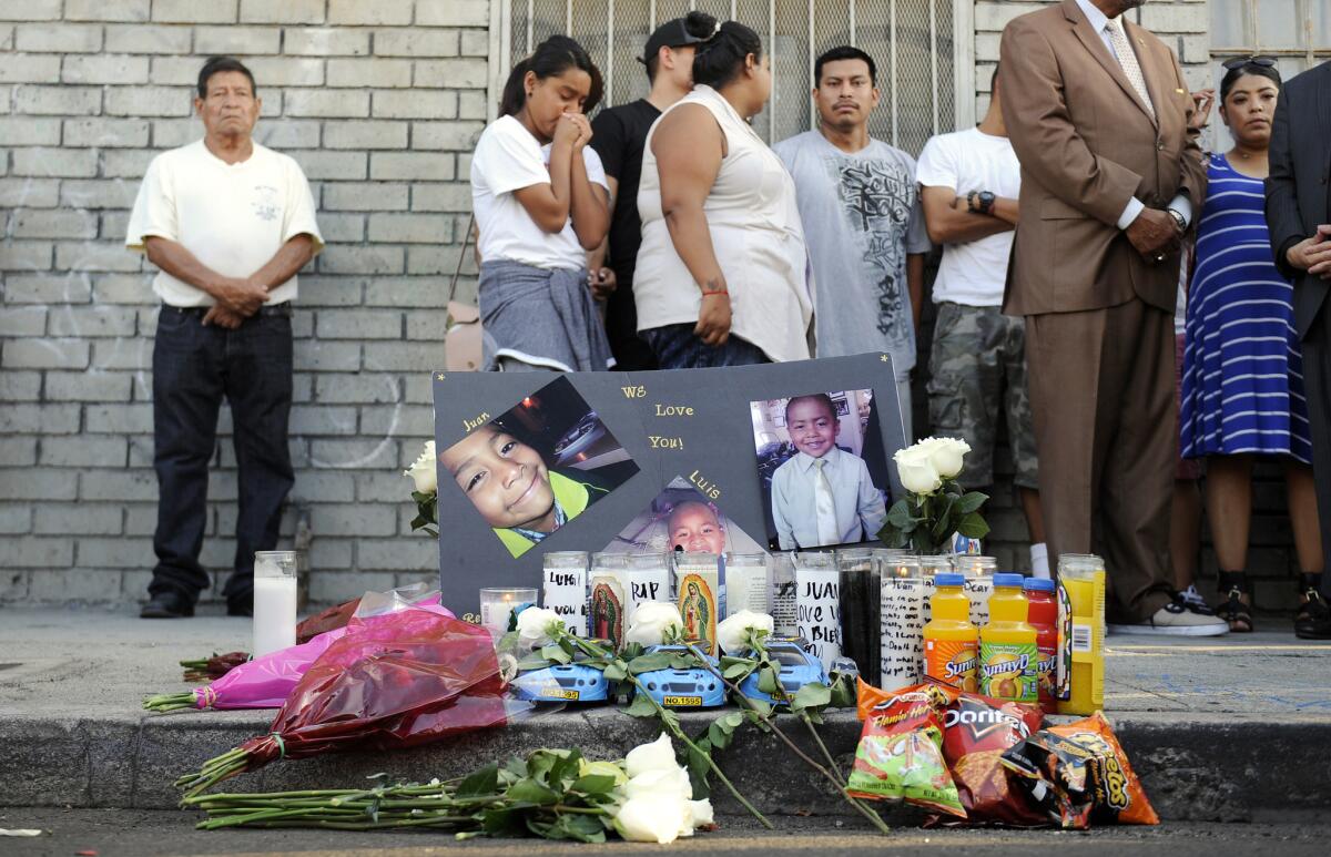 Family and community members mourn for three young brothers who were found Sept. 9 with fatal stab wounds in an SUV in South Los Angeles.