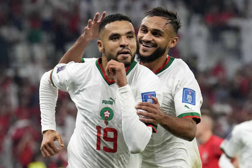 Morocco's Youssef En-Nesyri , left, celebrates beside Morocco's Sofiane Boufal, right, after he scored his side's second goal during the World Cup group F soccer match between Canada and Morocco at the Al Thumama Stadium in Doha , Qatar, Thursday, Dec. 1, 2022. (AP Photo/Natacha Pisarenko)