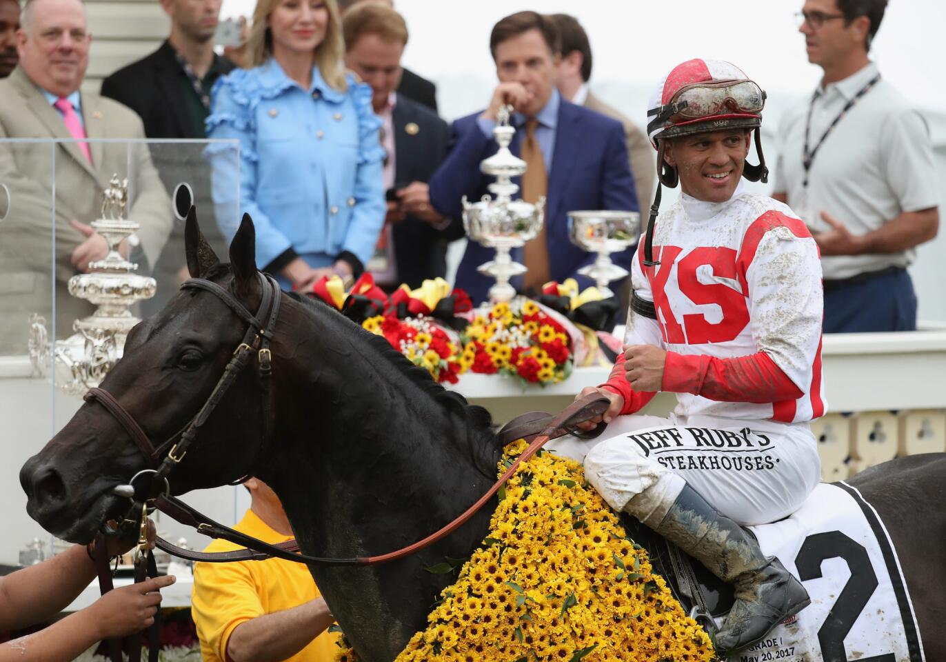 jockeyJavier Castellano poses for photos in the Winner's Circle withCloud Computingafter the 142nd running of the Preakness Stakes.