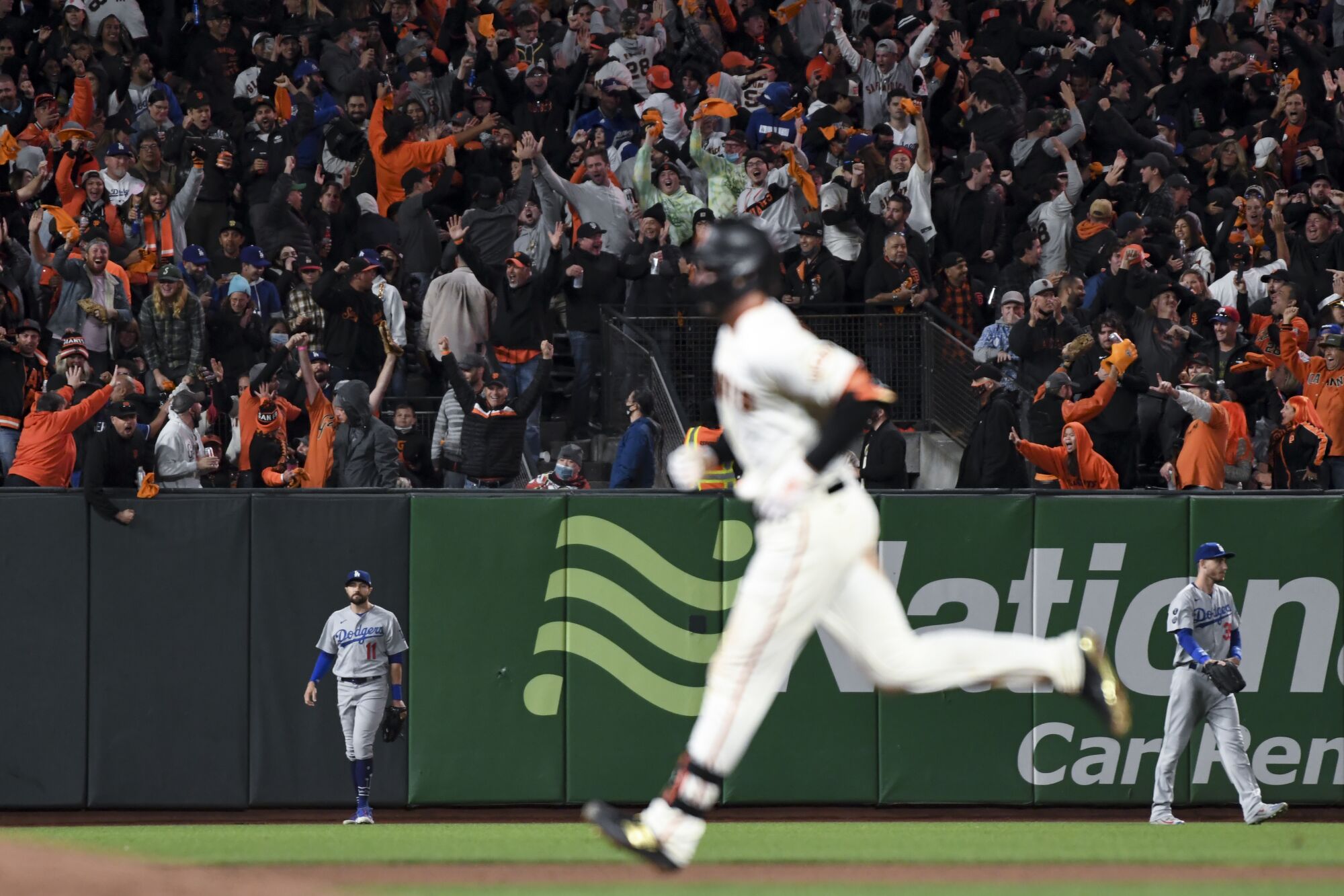 Fans cheer as San Francisco Giants' Kris Bryant rounds the bases off a solo home run