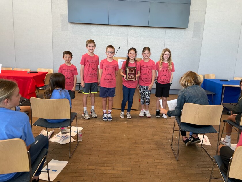 Andersen Elementary students pose with the Battle of the Books trophy on Wednesday, March 24.