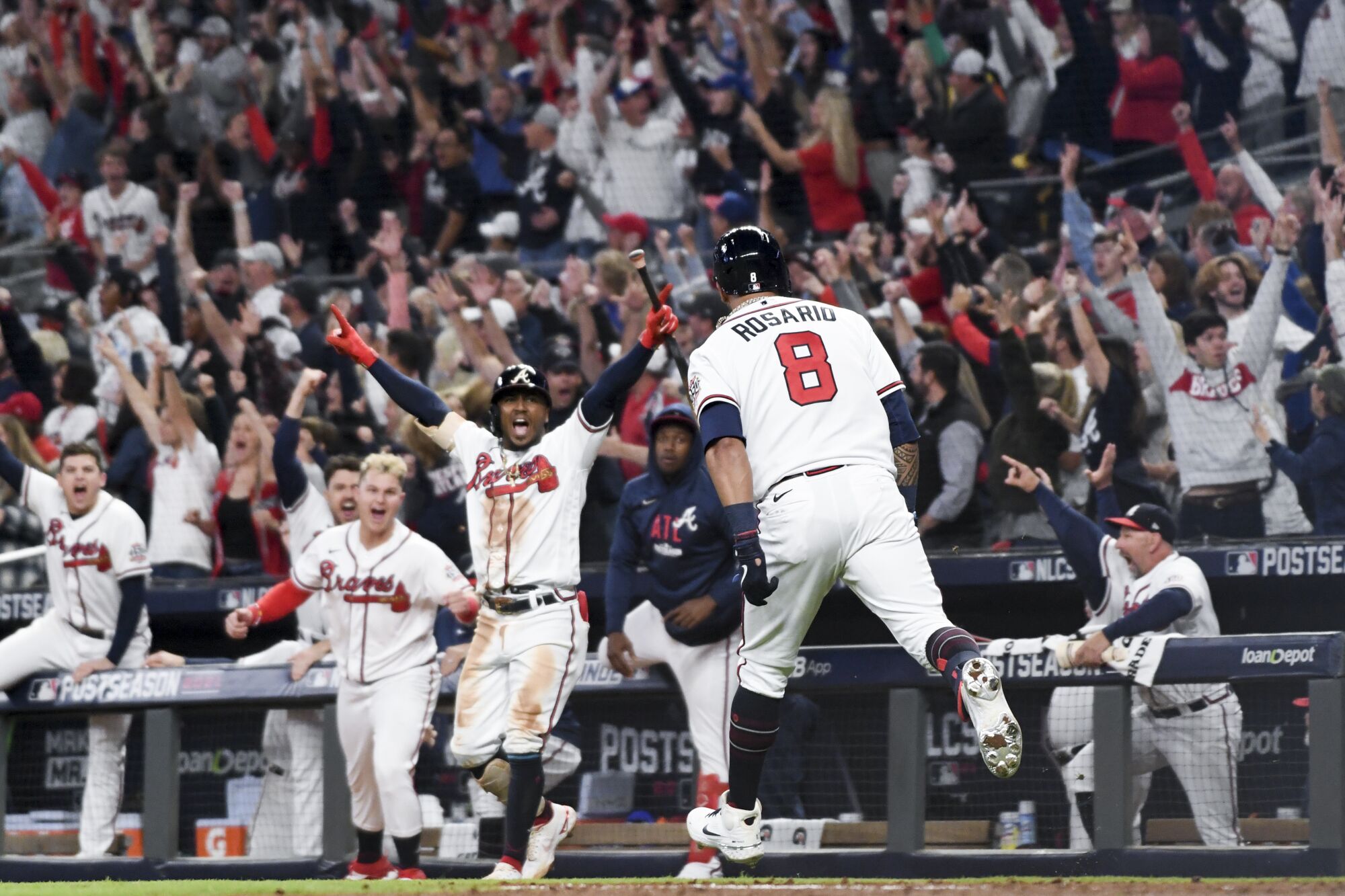 Braves' Eddie Rosario celebrates his three-run home run.