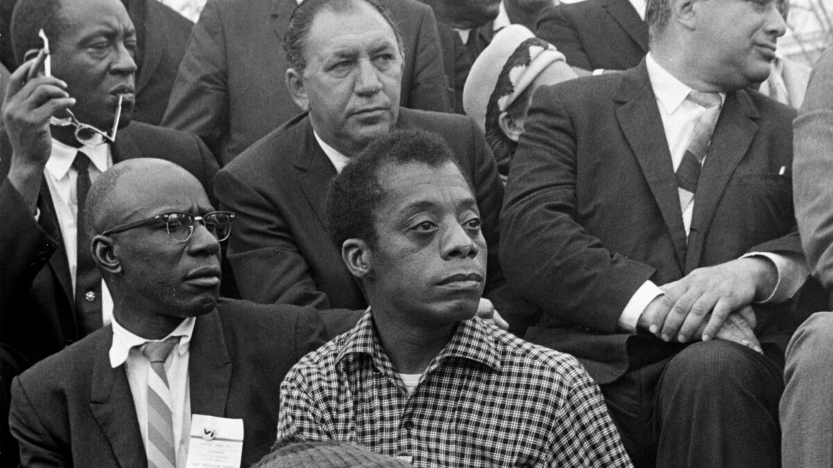 Writer James Baldwin listens to the Rev. Martin Luther King Jr. at the culmination of the Selma to Montgomery March in 1965. Baldwin was originally slated to appear with Harry Belafonte on David Susskind's "Open End" in 1963, before circumstances conspired to bring King onto the program.