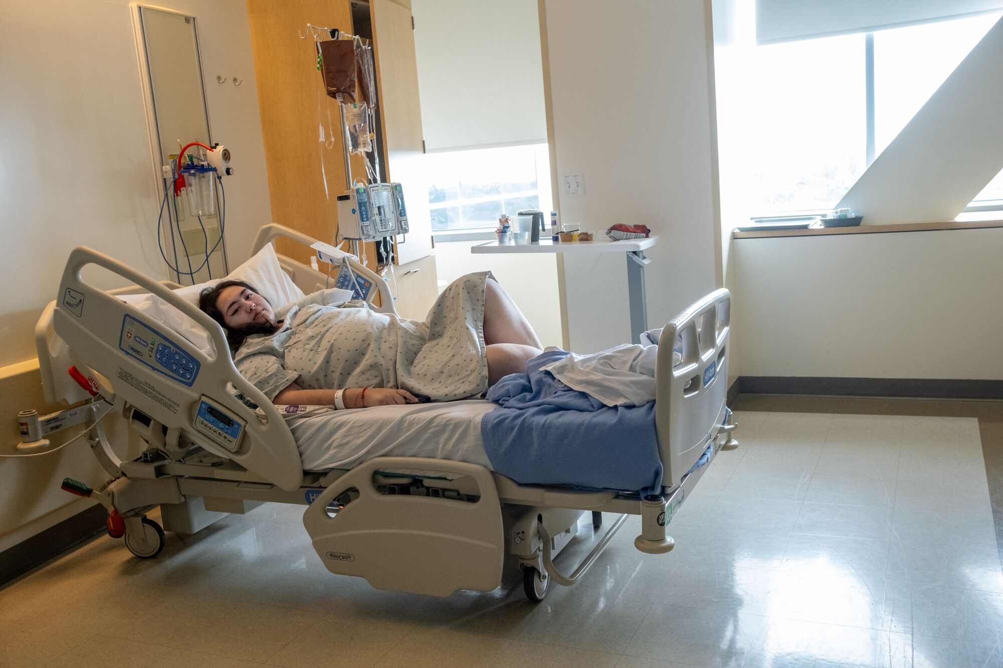 A woman reclined on a hospital bed