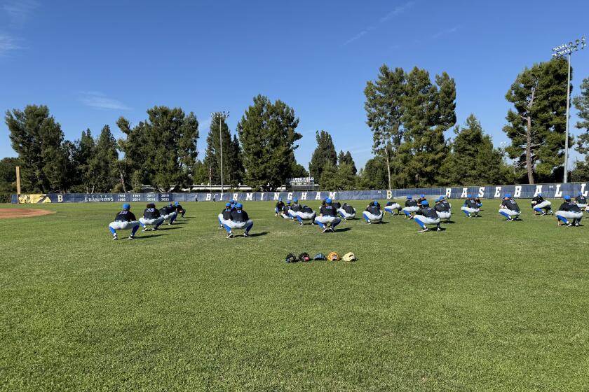 UCLA's baseball team stretches at Birmingham High on Thursday before practicing. 