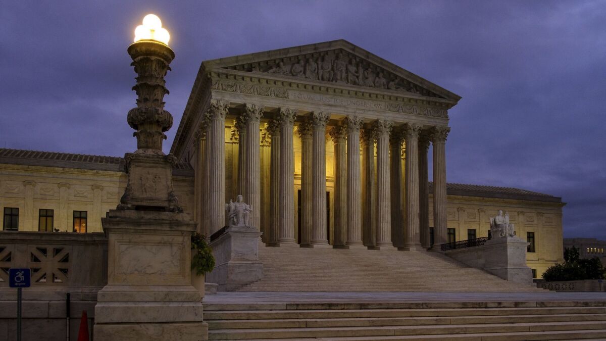The U.S. Supreme Court building before dawn in Washington.