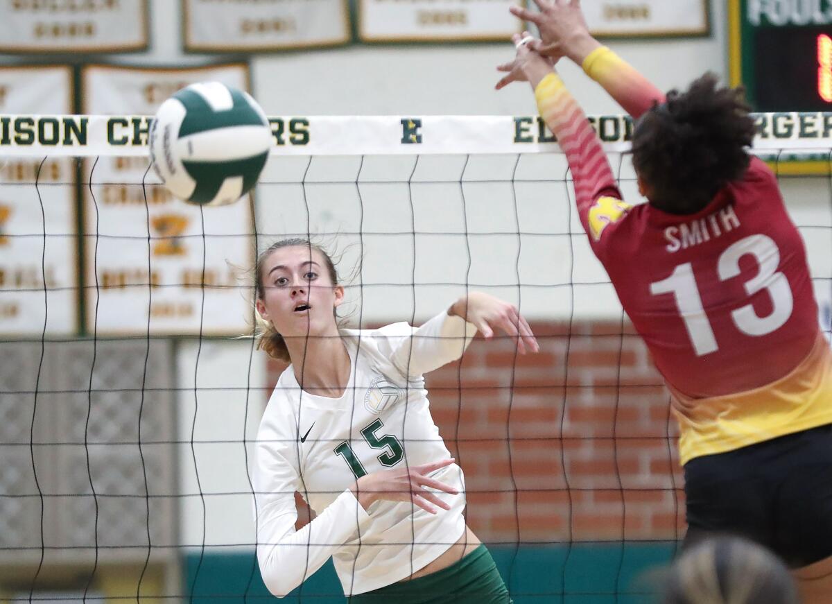 Edison opposite Molly McCuskey (15) puts a kill past the block of Long Beach Wilson's Allanah Smith (13) on Wednesday.