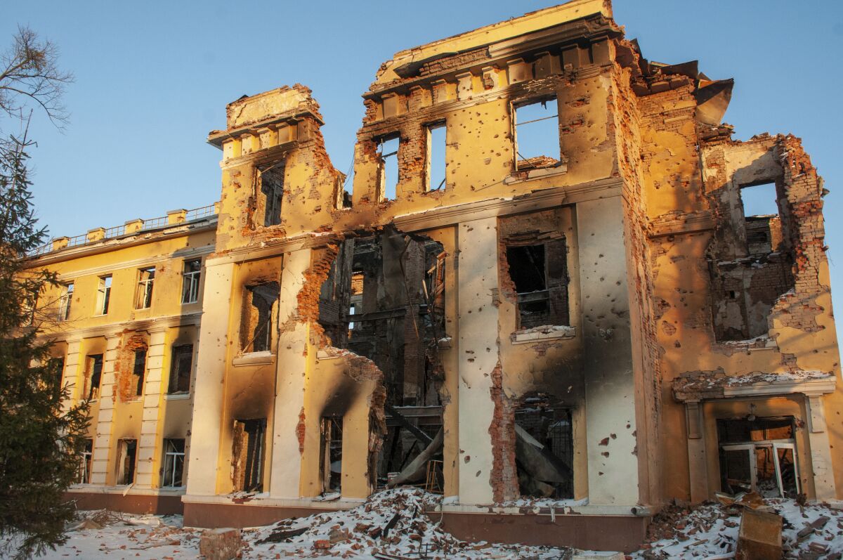 A damaged by shelling building is lit by sunset in Kharkiv, Ukraine, Friday, March 11, 2022. (AP Photo/Andrew Marienko)