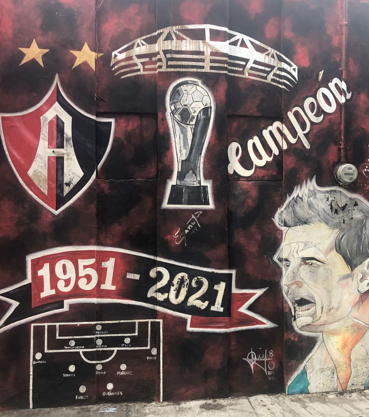 A mural depicts Atlas FC's last championship and the lineup across the street from Estadio Jalisco in Guadalajara.