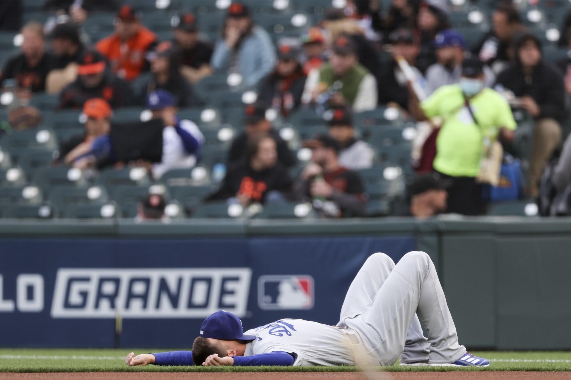  Dodgers' Corey Seager lays on the grass before the game.