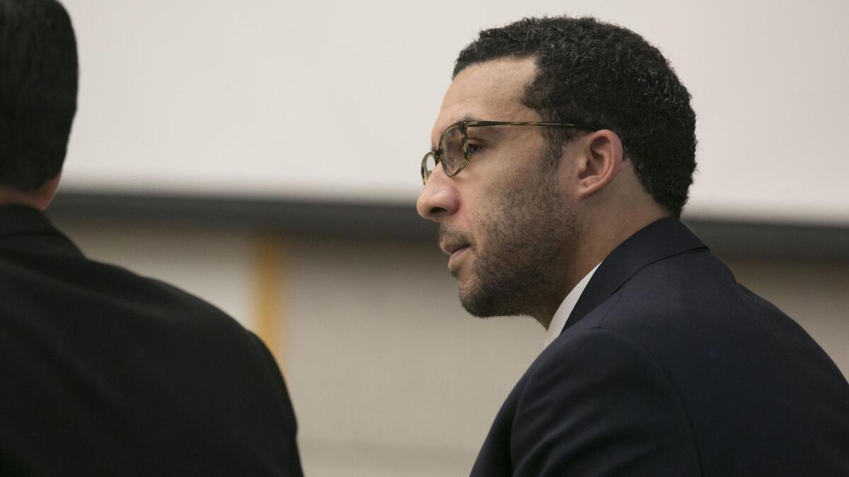 Former NFL football player Kellen Winslow Jr. looks at attorney Marc Carlos during his rape trial on Monday in Vista, Calif.