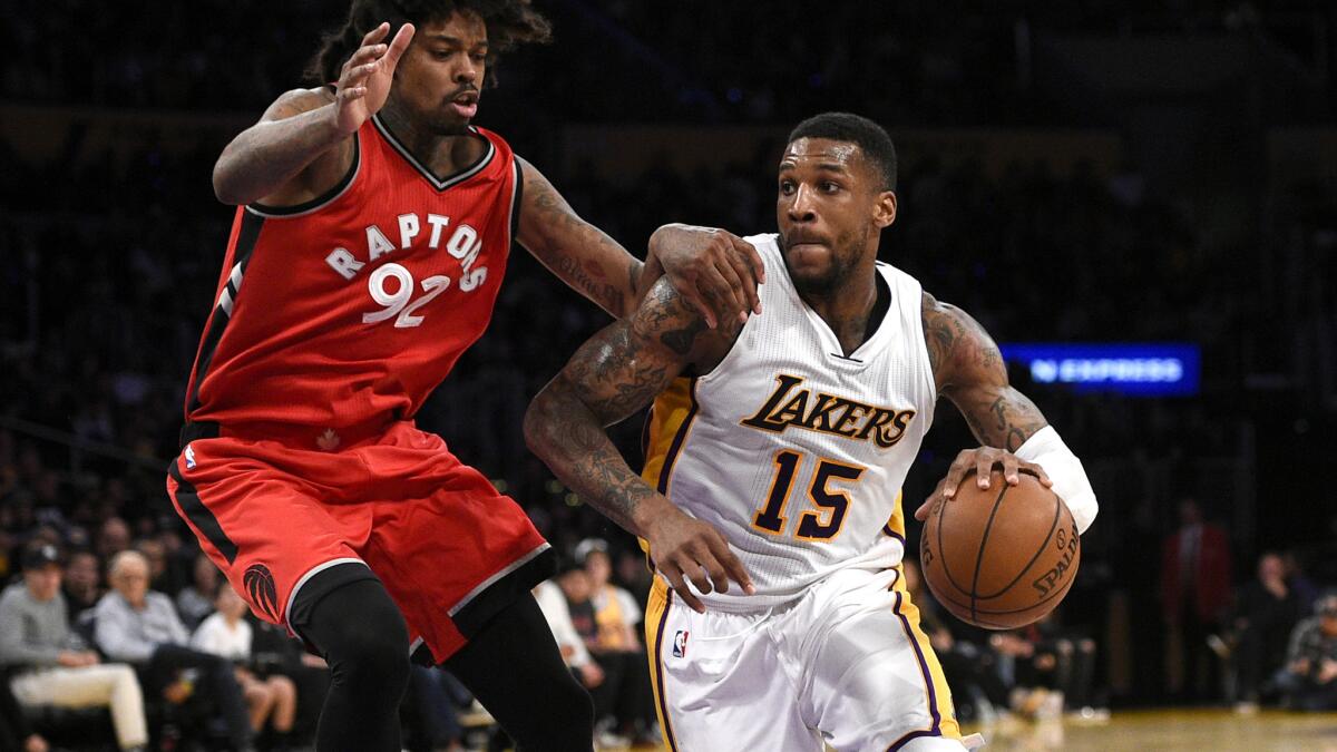 Lakers forward Thomas Robinson drives the lane against Toronto Raptors center Lucas Nogueira during the second half of a game Jan. 1.
