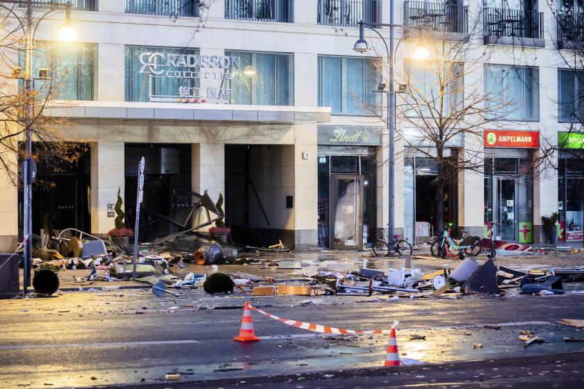 Debris lay on the street after a huge fish tank burst at the Seal Life Aquarium in central Berlin, Germany, Friday, Dec. 16, 2022. (Christoph Soeder/dpa via AP)