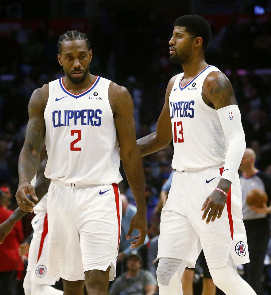 Clippers stars Kawhi Leonard and Paul George take the floor together during a game Nov. 20 against the Celtics at Staples Center.