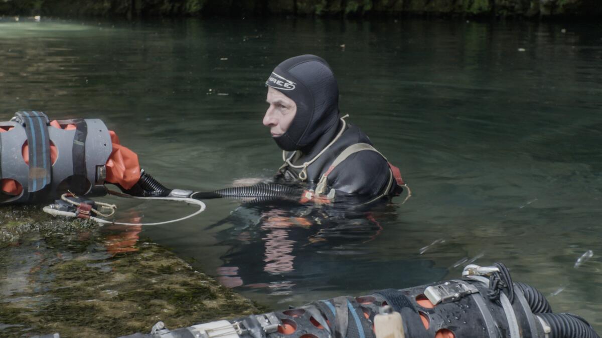 A diver in shoulder-deep water in the documentary "The Rescue."