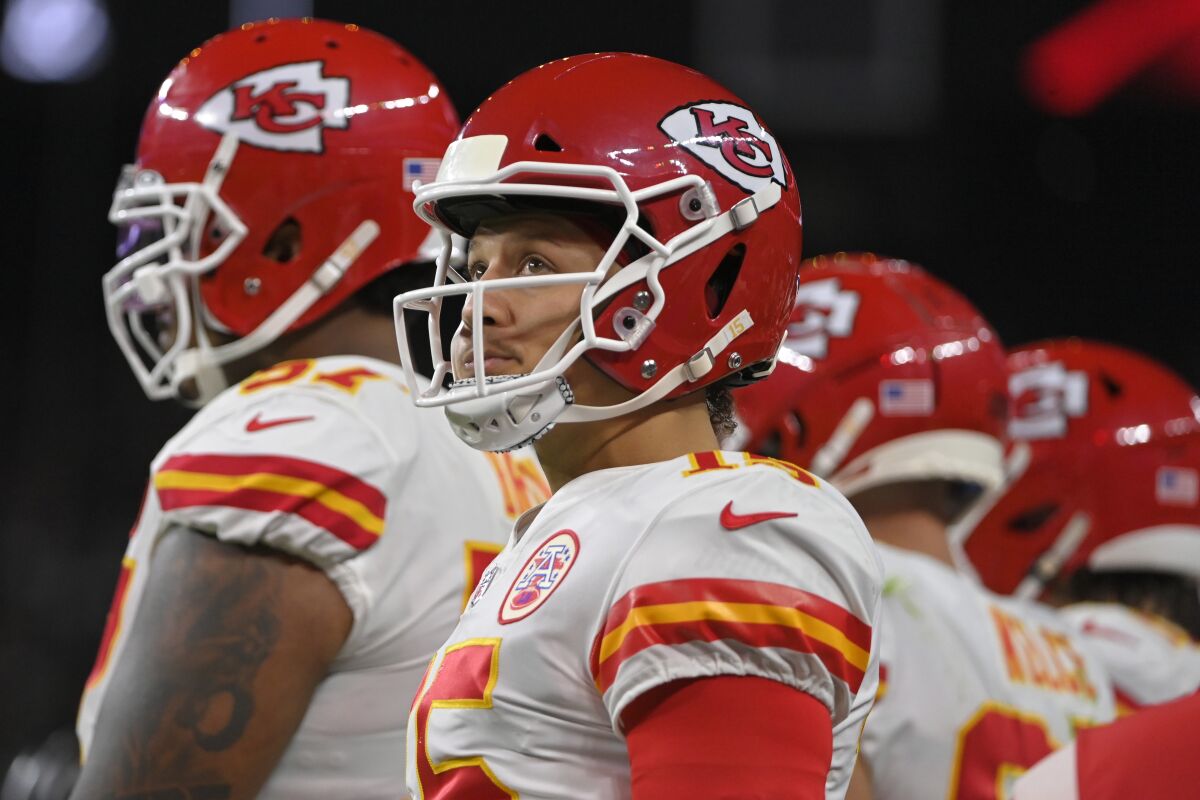 Kansas City Chiefs quarterback Patrick Mahomes (15) stands on the sidelines during the first half of an NFL football game against the Las Vegas Raiders, Sunday, Nov. 14, 2021, in Las Vegas. (AP Photo/David Becker)