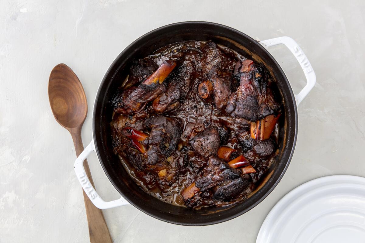 A pot of sticky-sour tamarind lamb shanks, a recipe by Ben Mims. 