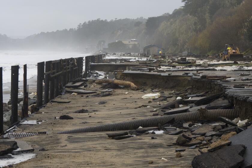 A parking lot at Seacliff State Beach is damaged by heavy storm surge, Thursday, Jan. 5, 2023, in Aptos, Calif.