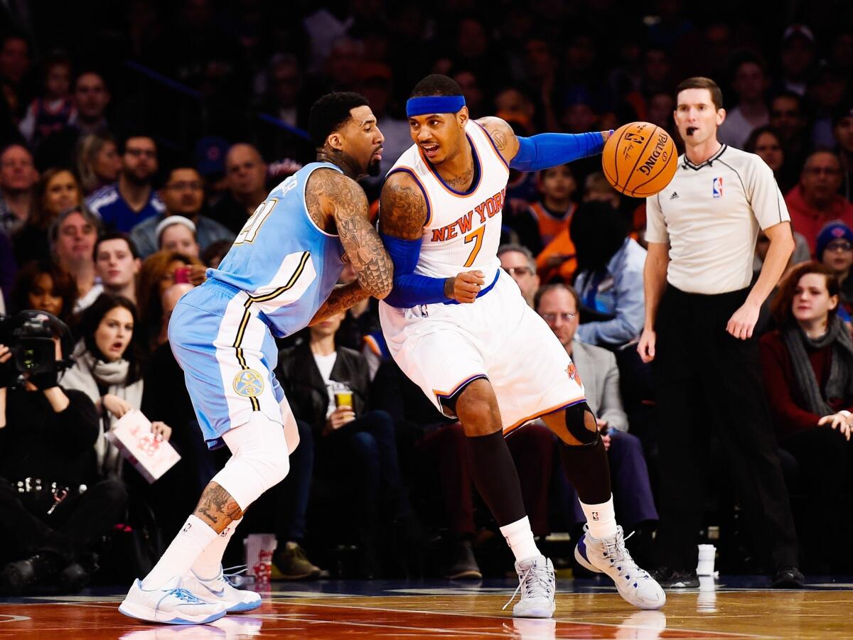 New York's Carmelo Anthony dribbles around Denver's Wilson Chandler during the first half of the Knicks' 109-93 win over the Nuggets. Anthony had 28 points, nine rebounds and one steal.