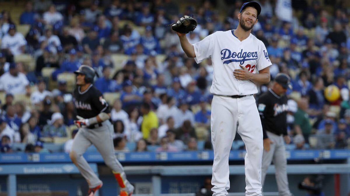 Dodgers starting pitcher Clayton Kershaw doesn't watch as Miami Marlins Miguel Rojas rounds the bases after hitting a three-run homer in the fifth inning at Dodger Stadium on Wednesday.
