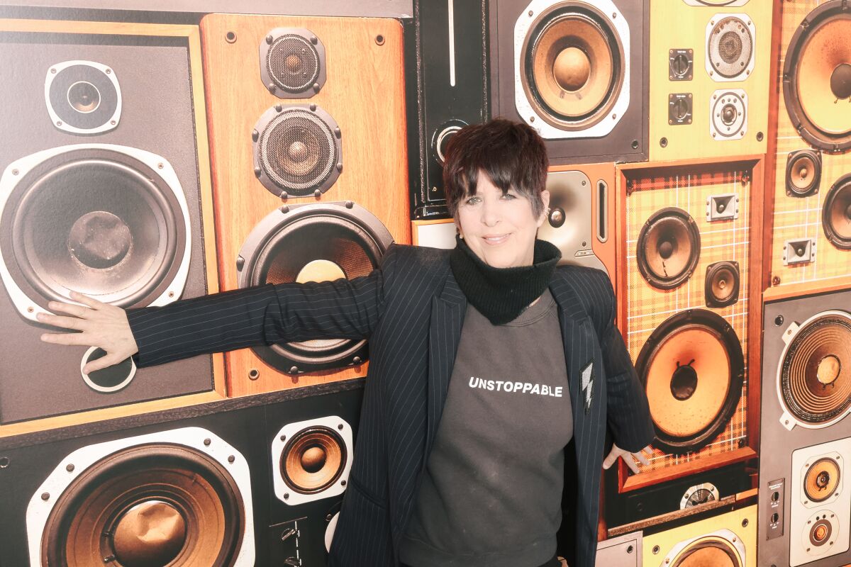 Songwriter Diane Warren poses for a portrait against a wall of amps at her studio.