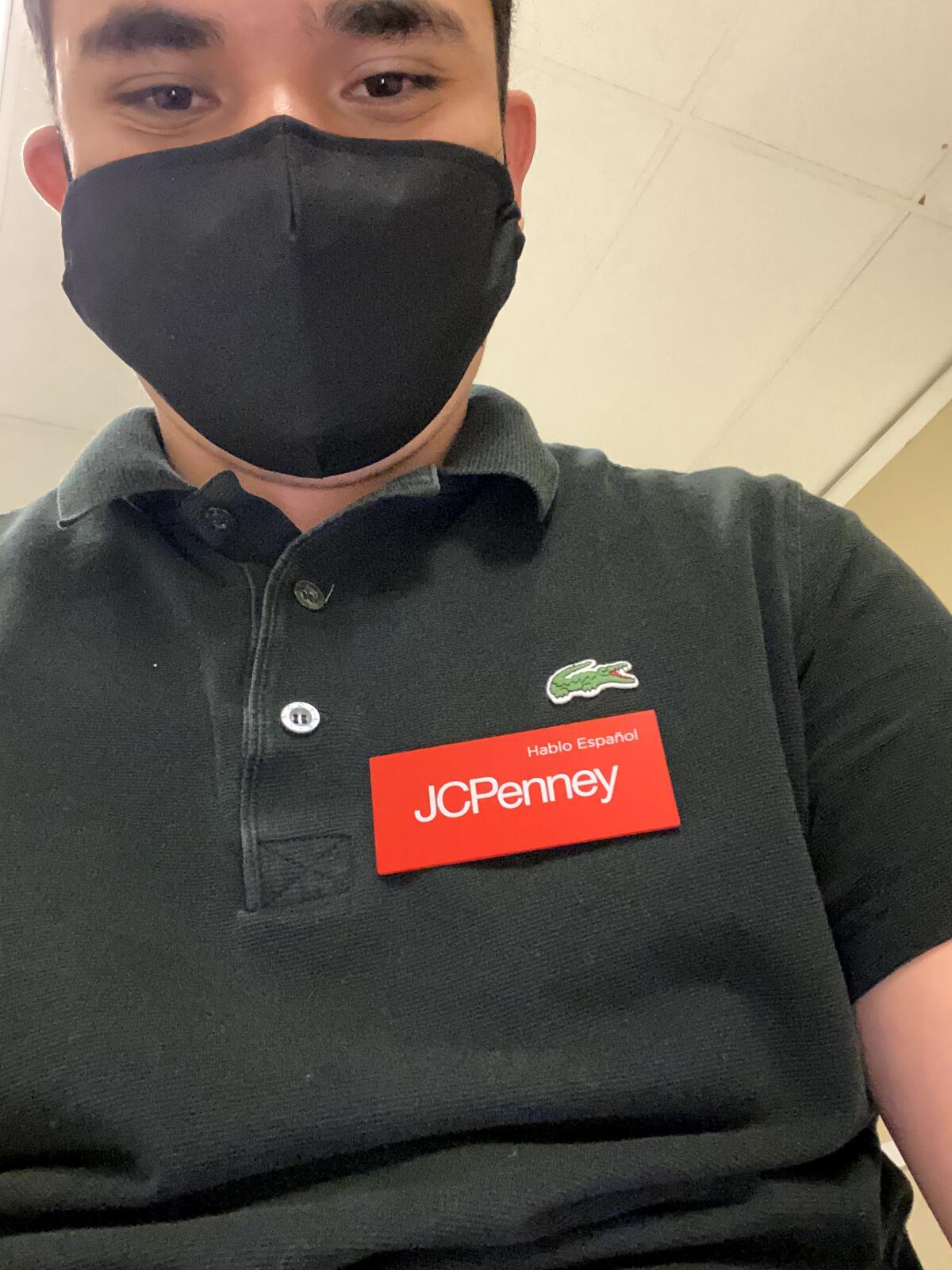Antonio Solorio in a mask and wearing a JCPenney name tag.