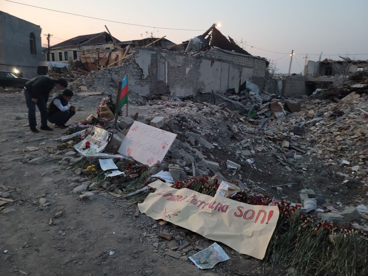 Children gather at the site of a missile barrage in the city of Ganja, Azerbaijan.