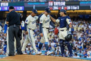 Dodgers manager Dave Roberts and catcher Austin Barnes console pitcher River Ryan as he's pulled from the game 