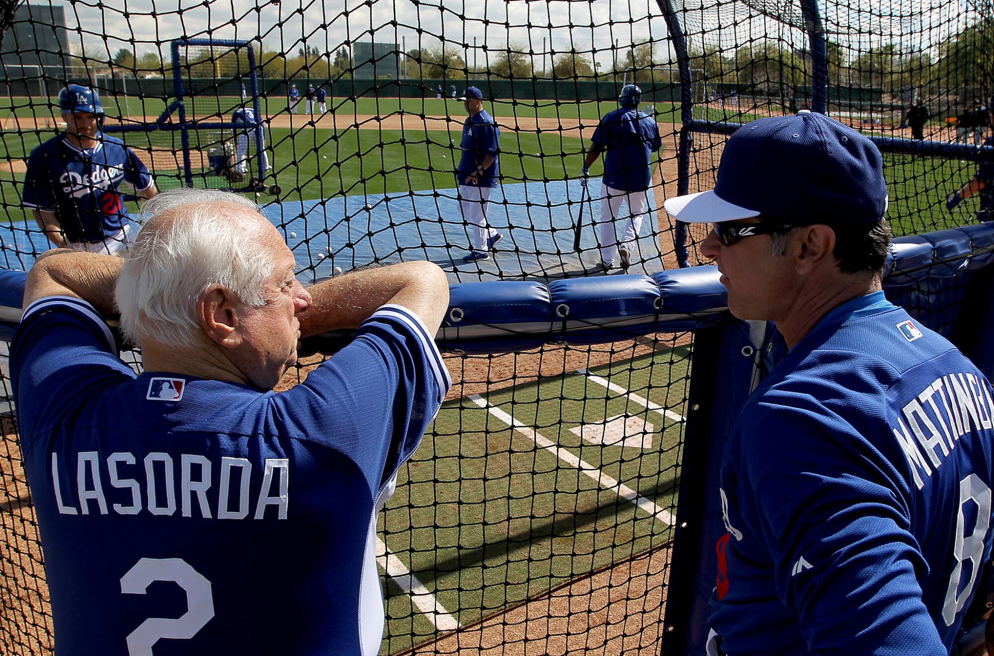 Then-Dodgers manager Don Mattingly, right, talks with Tommy Lasorda during Dodgers spring training in in March 2010.