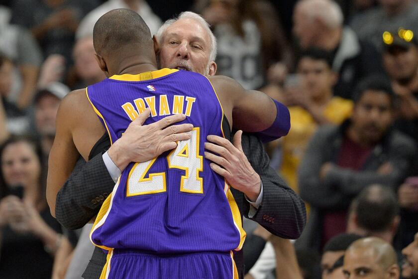 Kobe Bryant hugs San Antonio Coach Gregg Popovich before the Lakers played the Spurs on Feb. 6.