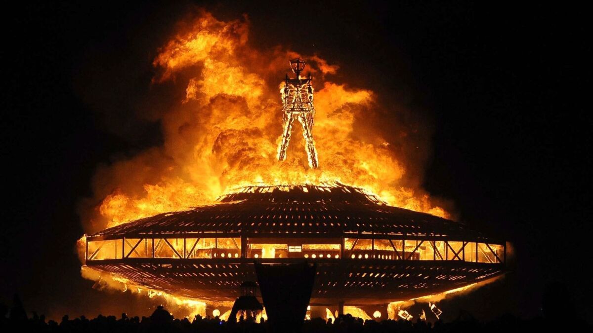 In this Aug. 2013 file photo, the "Man" burns on the Black Rock Desert at Burning Man near Gerlach, Nev.