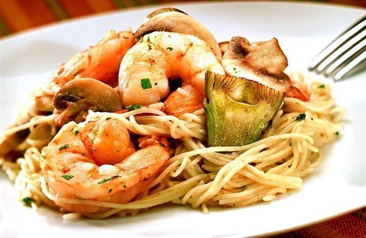 Pasta is tossed with plump shrimp and artichokes.
