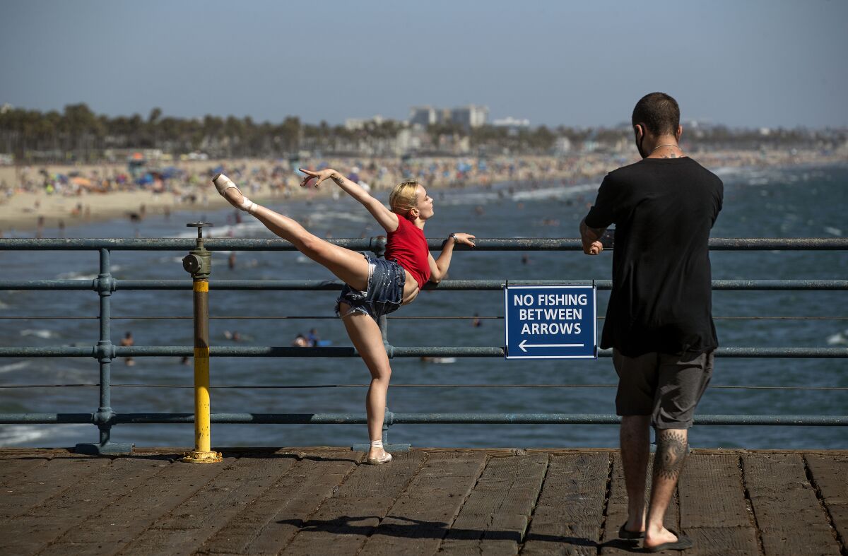 Ekaterina Pokrovskaya, of Las Vegas, shows off her ballet moves for a photographer on the Santa Monica Pier.  