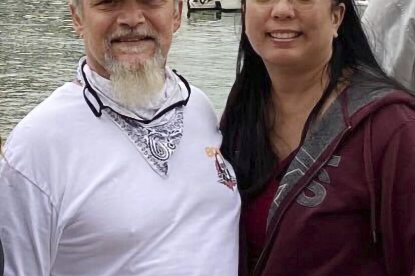 This undated photo provided by James Solis shows Robert Solis, left and his partner Brandi Tyau, right. Robert Solis and Tyau were aboard the charter fishing vessel Awakin when it was scuttled Sunday in rough seas off the coast of southeast Alaska. The bodies of three of the five people aboard have been found but two people remain missing. Authorities are working to salvage the boat, which was found partially submerged off an island near Sitka, Alaska. Those on the vessel were Solis and Tyau, Tyau's sister and her partner and the boat captain. (James Solis via AP)