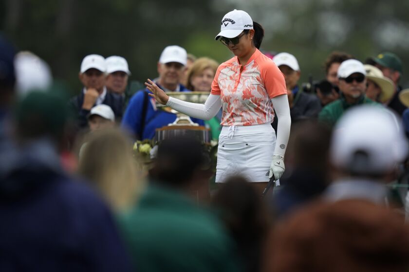 Rose Zhang acknowledges the crowd before teeing off on the first hole during the final round of the Augusta National Women's Amateur golf tournament, Saturday, April 1, 2023, in Augusta, Ga. (AP Photo/Matt Slocum)